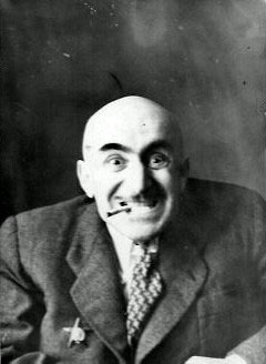 “With a cigarette”, a comic photo of Mikhail Verzhbinsky, grinning and with a cigarette